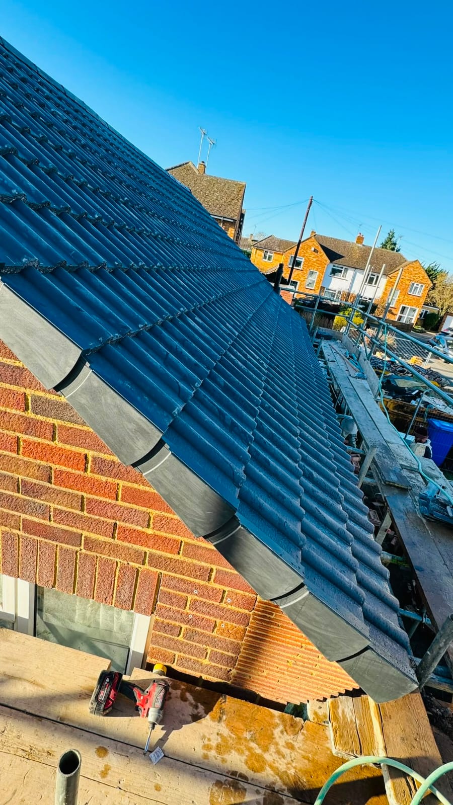 Completed tiled roof with new ridge tiles and guttering in North Wales