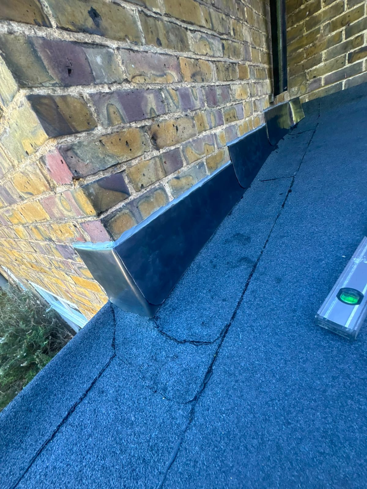 Finished lead flashing and lead valley work on a slate roof