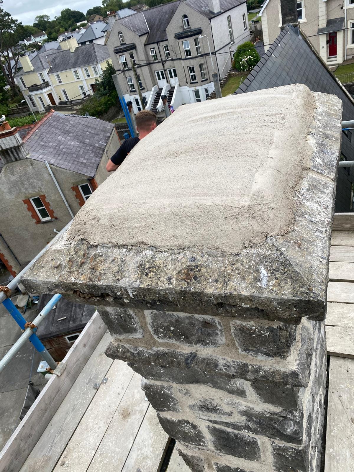 Repointed chimney stack with new lead flashing after repair, North Wales