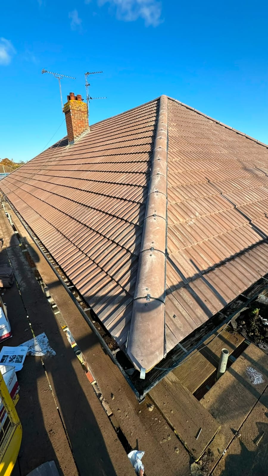 Completed tiled roof with new ridge tiles and guttering in North Wales