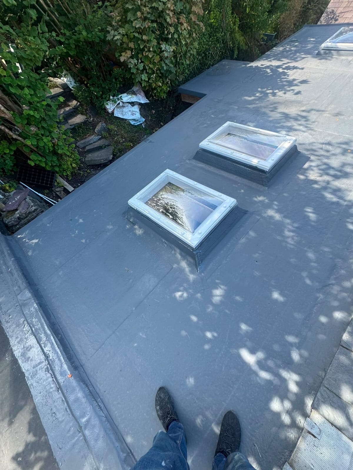 Completed flat roof replacement with clean seams and new edge trims
